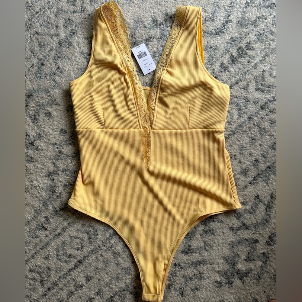 Woman’s Ripped Yellow Bodysuit by Buckle
